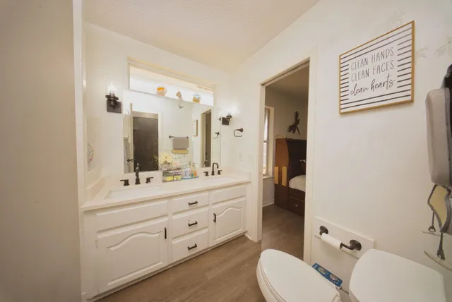 a bathroom with a toilet a sink and mirror