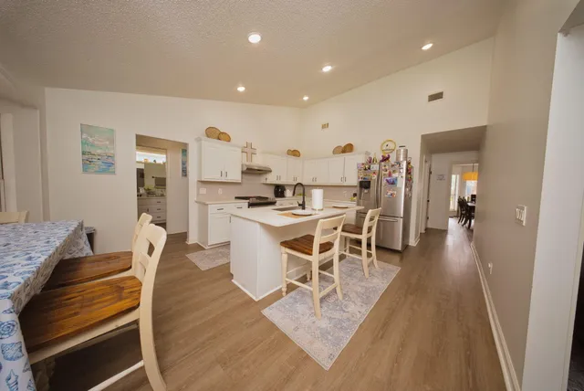 a dining room with furniture and wooden floor