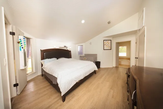 a bedroom with a bed and window