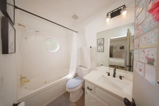 a bathroom with a sink mirror toilet and shower