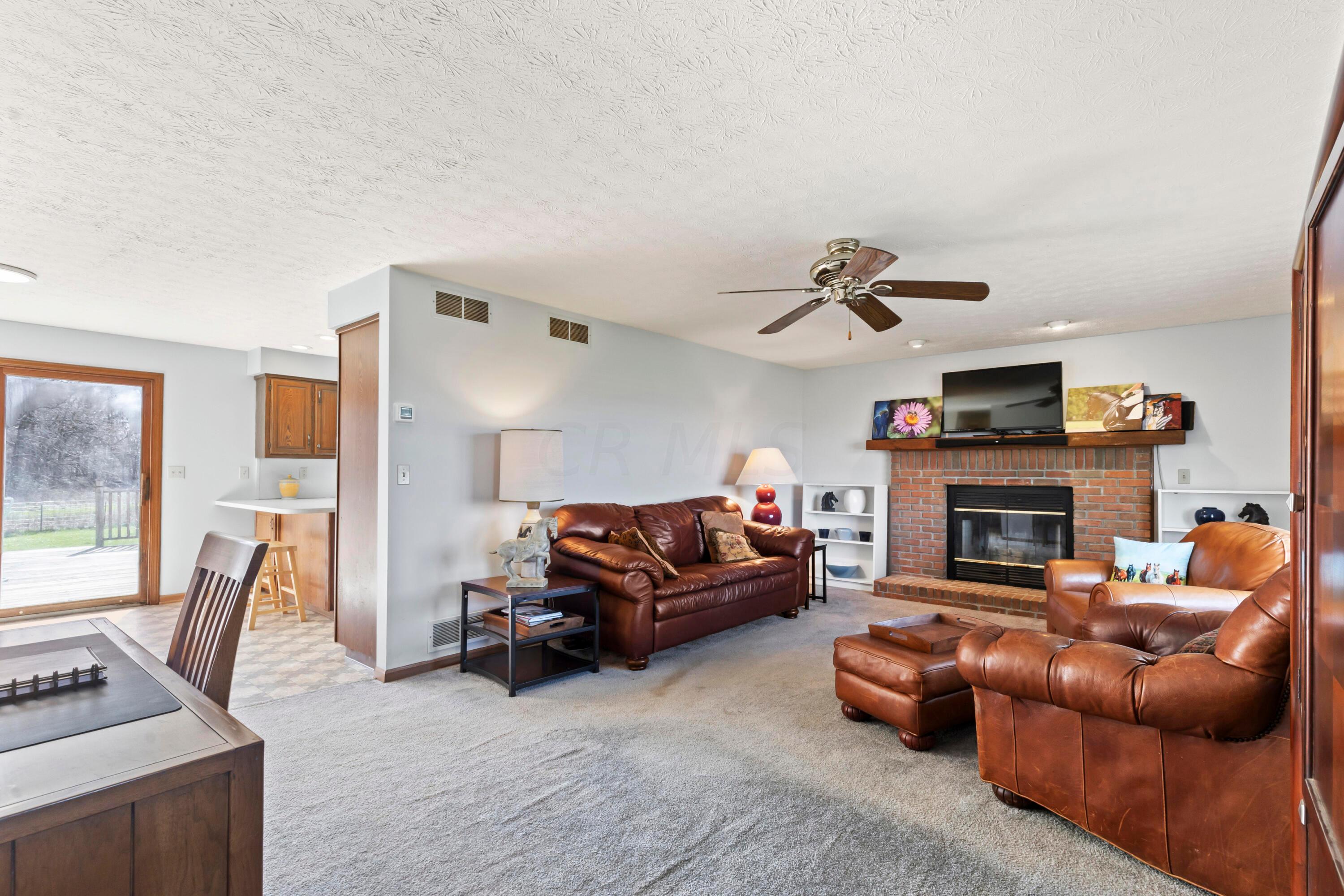 • Light sand carpet
• Ivory painted walls
• Woodburning brick fireplace
with mantle, heatilator & raised
hearth
• Can lighting
• Ceiling fan
• 2” blinds