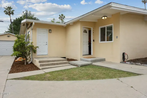 a front view of a house with garden