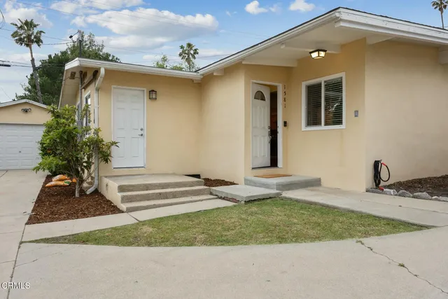 a front view of a house with garden