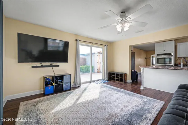 a bedroom with furniture and a flat screen tv