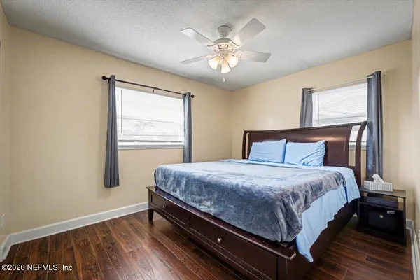 a bedroom with a large bed and a chandelier
