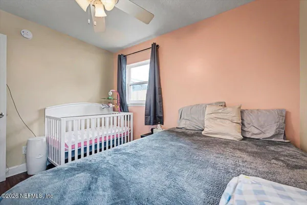 a bedroom with a bed and a chandelier