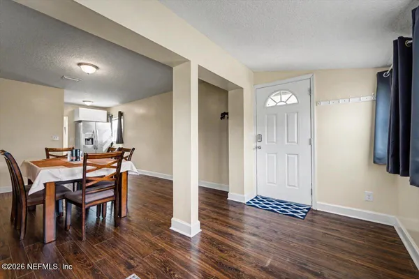 a view of a dining room with furniture and wooden floor