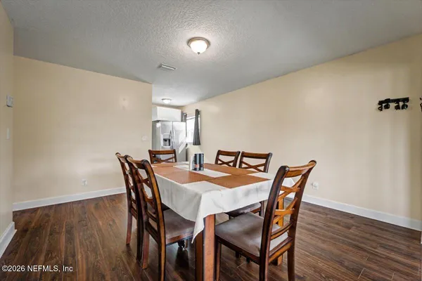 a view of a dining room with furniture and wooden floor