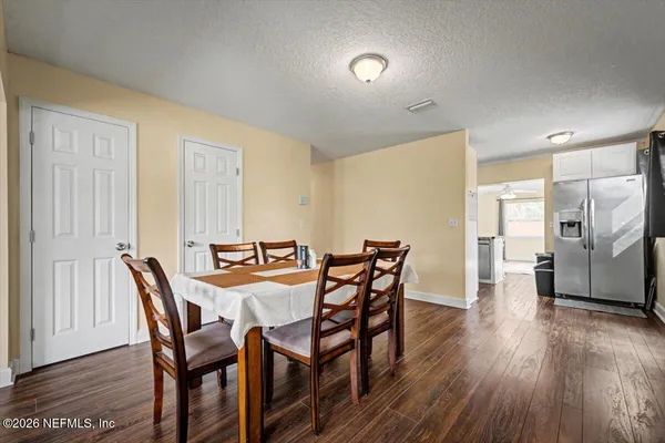 a view of a dining room with furniture and wooden floor