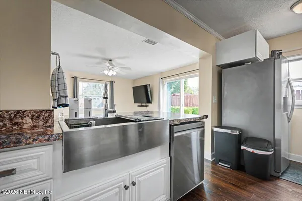 a kitchen with stainless steel appliances granite countertop a sink stove and refrigerator
