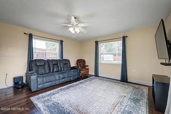 a living room with furniture and a flat screen tv