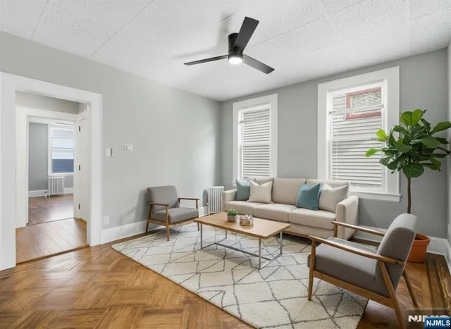 a living room with furniture and a potted plant