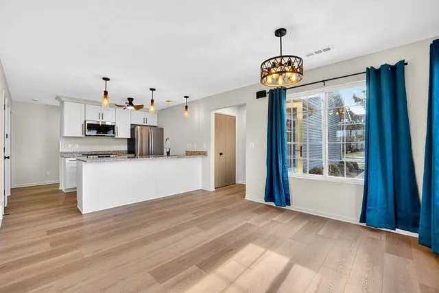 a view of a kitchen with an empty space and a window