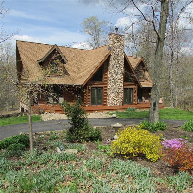 True amish custom built log home,10 years old."D cut" Square Wood. Situated on 6.46 acres. Asphalt drive. GREAT FOR HORSES!!! Fenced pasture.