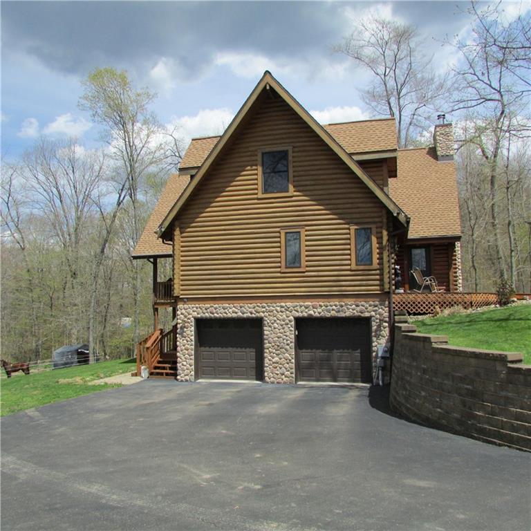 189 Upper Service Road Hookstown, PA 15050 - Photo 3 of 25 Side view of home. All stone surround on garage doors. Asphalt drive. Retaining wall.