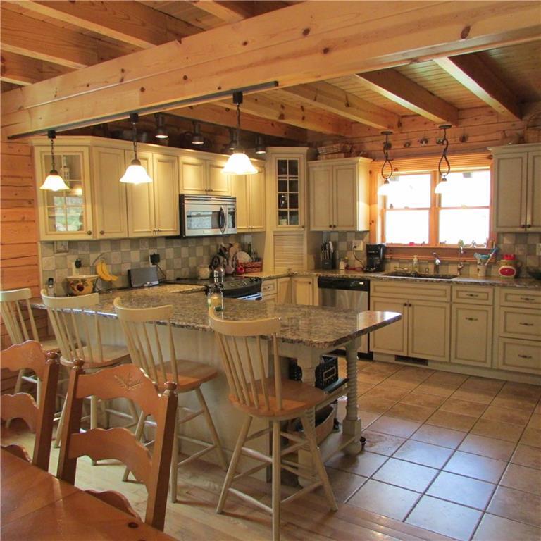189 Upper Service Road Hookstown, PA 15050 - Photo 5 of 25 Stunning open beam ceiling throughout the home.Custom kitchen cabinetry with washed coffee finish. Granite counter tops, tile backsplash. Hardwood floors except the kitchen which is tile,bathrooms and gameroom.