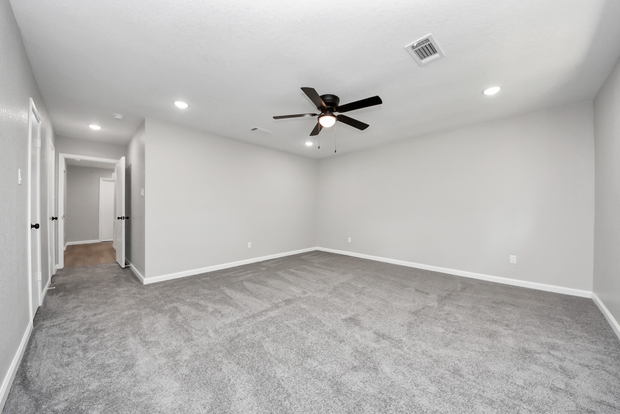 2402 Rolling Glen Drive Spring, TX 77373 - Photo 26 of 38 an empty room with a ceiling fan and a window