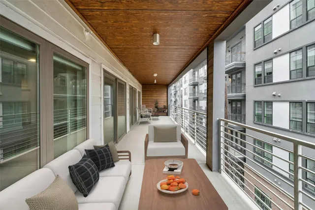 a balcony with furniture and a potted plant