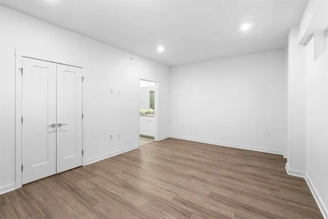 a view of an empty room with wooden floor