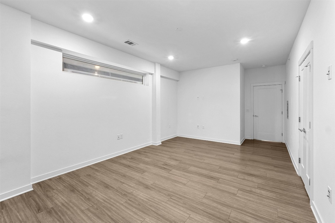 4361 South Congress Avenue, Unit 333 Austin, TX 78745 - Photo 18 of 40 a view of an empty room with wooden floor