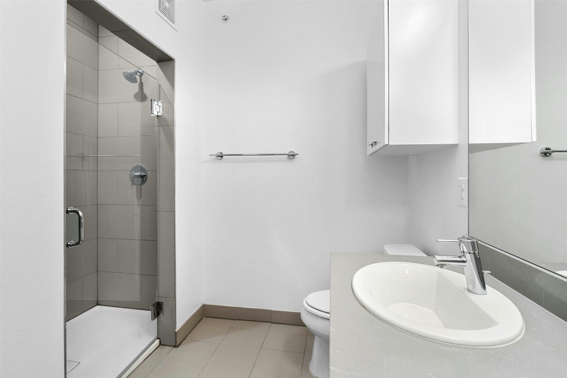 4361 South Congress Avenue, Unit 333 Austin, TX 78745 - Photo 20 of 40 a bathroom with a sink a toilet and shower