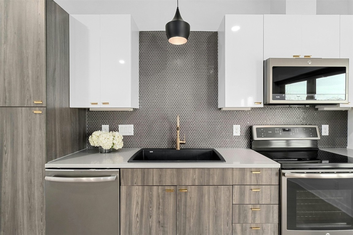 4361 South Congress Avenue, Unit 333 Austin, TX 78745 - Photo 2 of 40 a kitchen with a sink cabinets and appliances