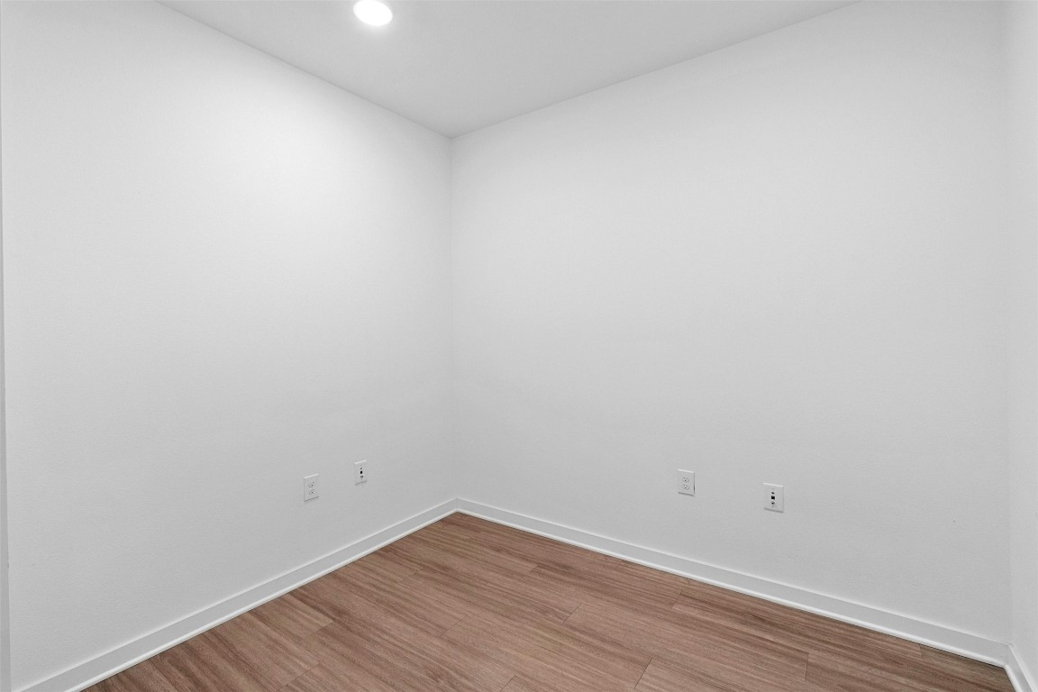 4361 South Congress Avenue, Unit 333 Austin, TX 78745 - Photo 27 of 40 a view of an empty room with wooden floor