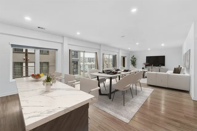 a view of a dining room with furniture and wooden floor