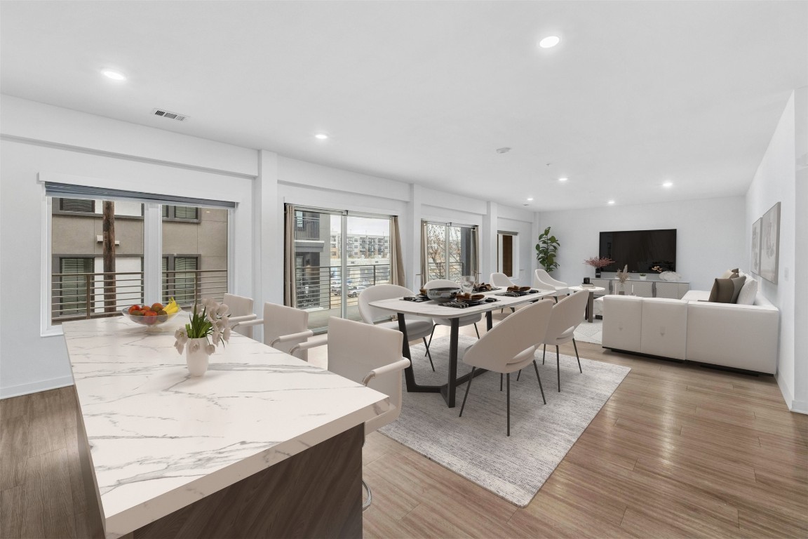 4361 South Congress Avenue, Unit 333 Austin, TX 78745 - Photo 4 of 40 a view of a dining room with furniture and wooden floor