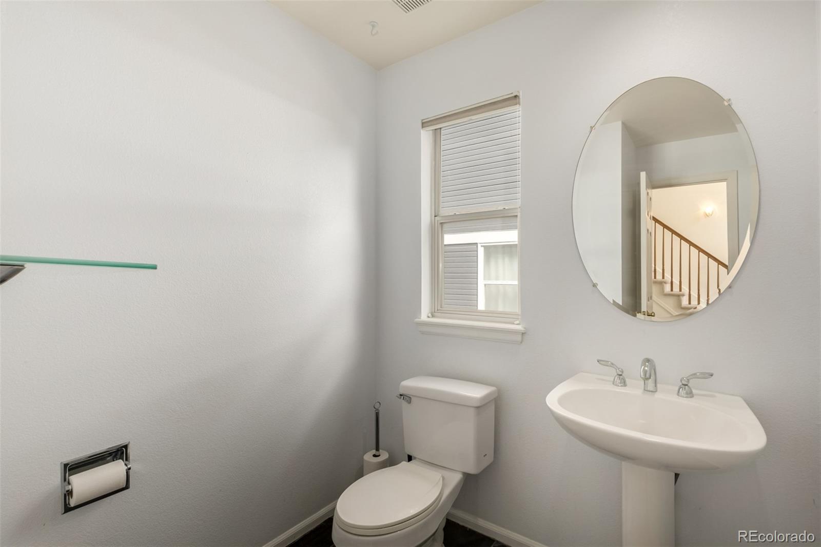707 Huntington Place Highlands Ranch, CO 80126 - Photo 15 of 50 a bathroom with a toilet a sink and mirror