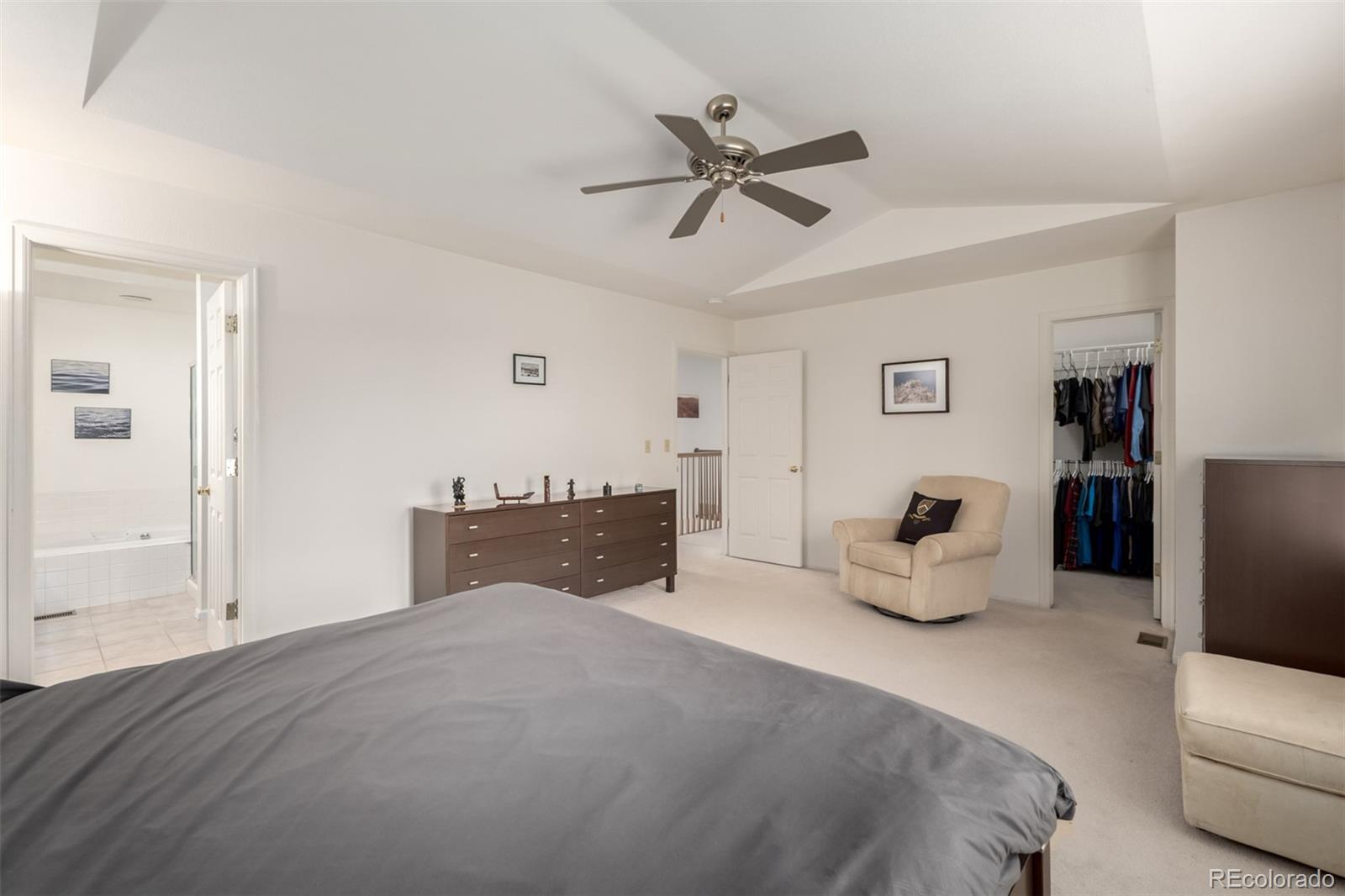 707 Huntington Place Highlands Ranch, CO 80126 - Photo 17 of 50 a bedroom with a bed and a chandelier