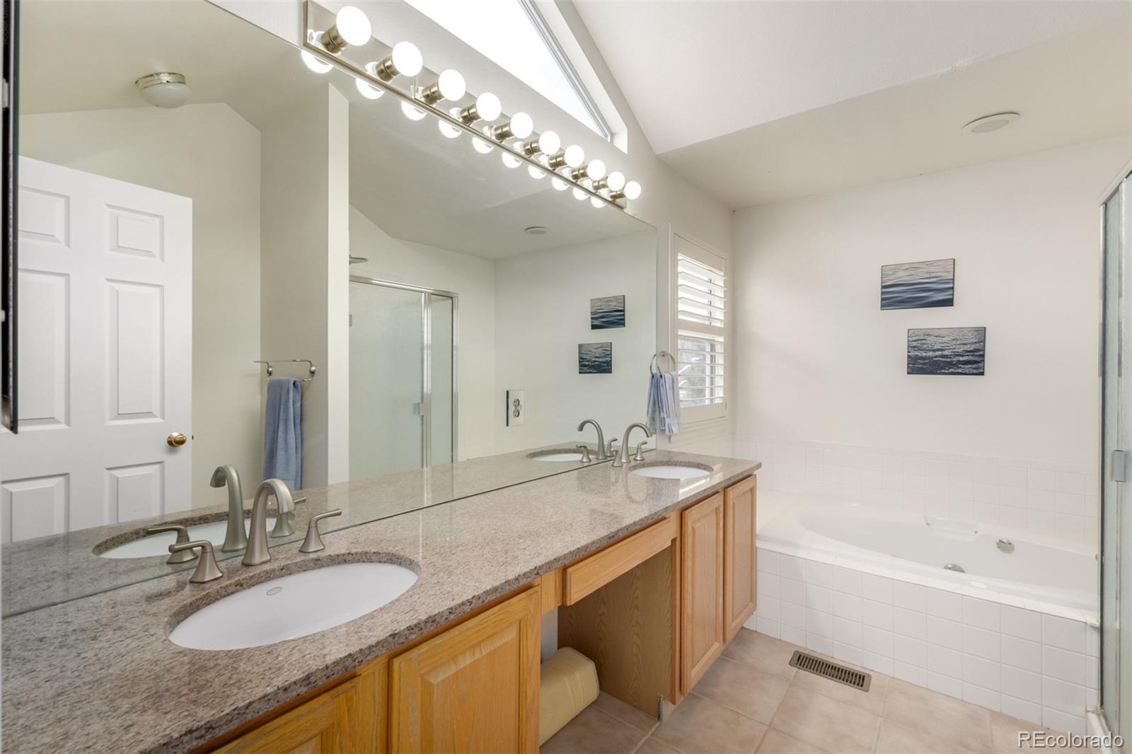 707 Huntington Place Highlands Ranch, CO 80126 - Photo 18 of 50 a bathroom with a granite countertop double vanity sink and a mirror