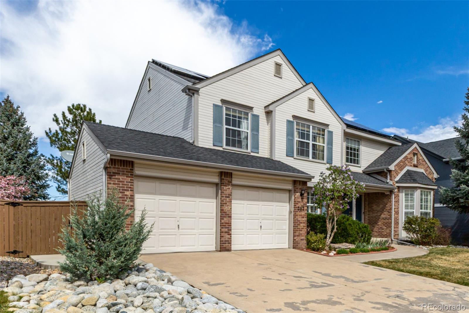 707 Huntington Place Highlands Ranch, CO 80126 - Photo 2 of 50 a front view of a house with a yard
