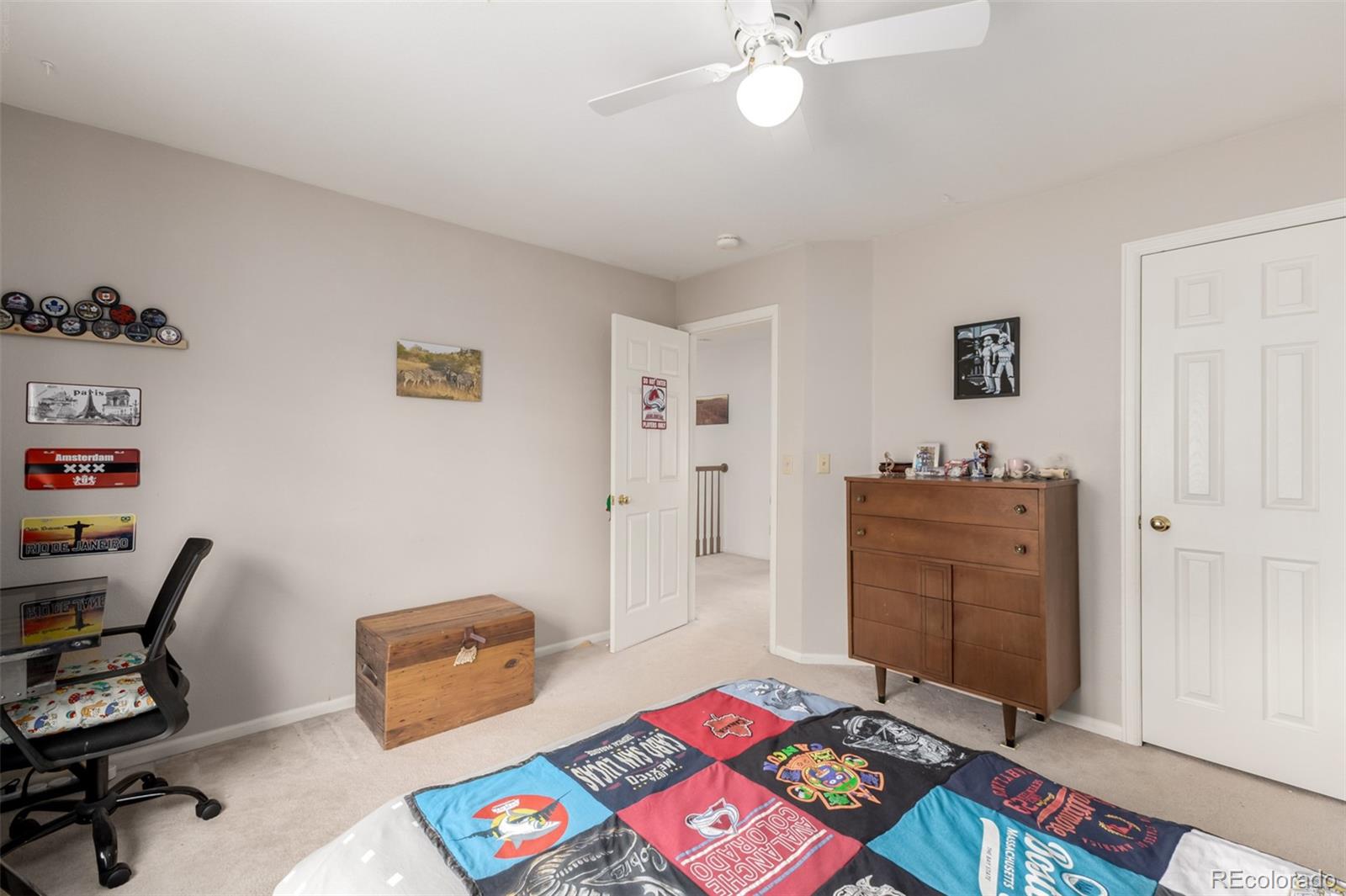 707 Huntington Place Highlands Ranch, CO 80126 - Photo 21 of 50 a bedroom with a bed and a bookshelf