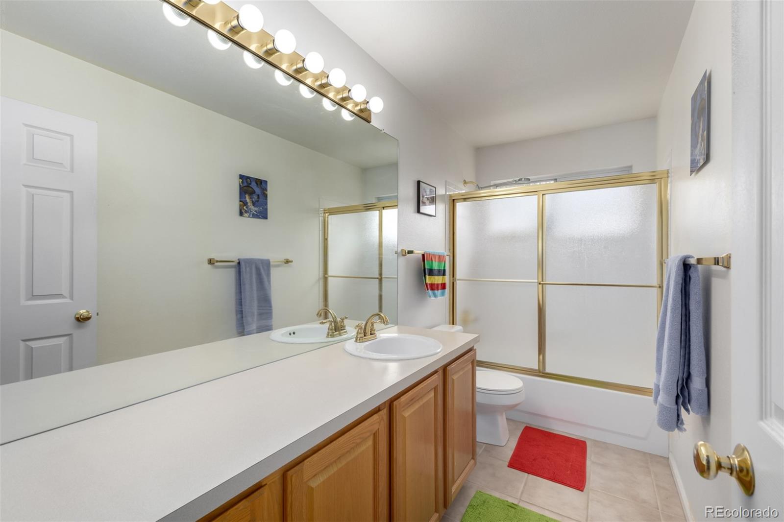 707 Huntington Place Highlands Ranch, CO 80126 - Photo 22 of 50 a bathroom with a sink a mirror and a shower