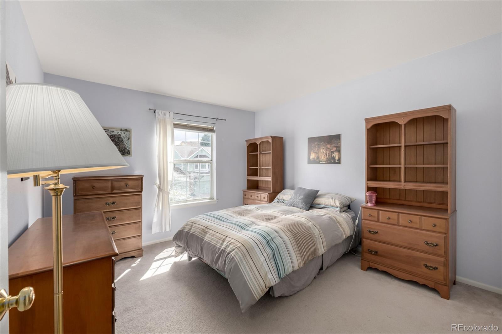 707 Huntington Place Highlands Ranch, CO 80126 - Photo 23 of 50 a bedroom with a bed and a window