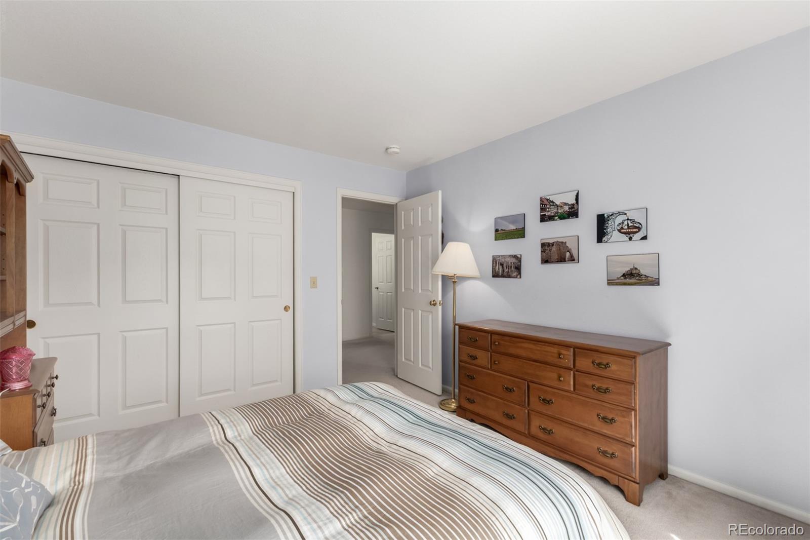 707 Huntington Place Highlands Ranch, CO 80126 - Photo 24 of 50 a bedroom with a bed and a dresser
