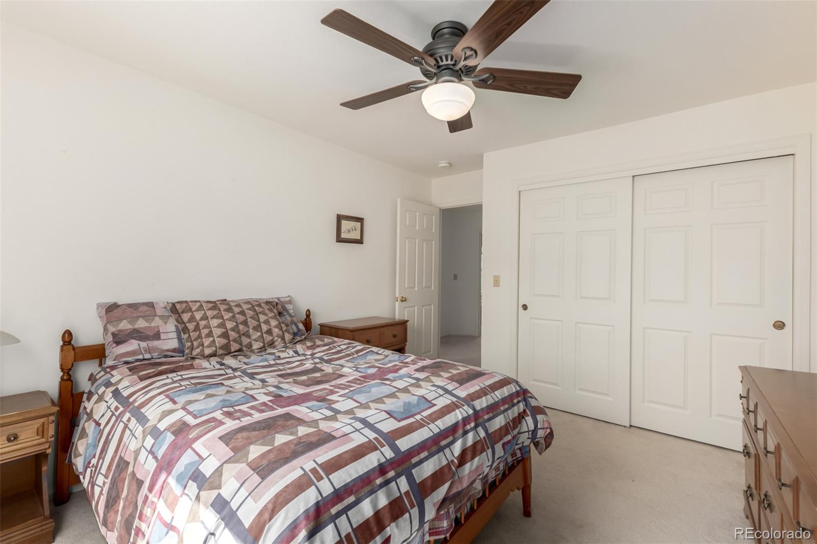 707 Huntington Place Highlands Ranch, CO 80126 - Photo 26 of 50 a bedroom with a bed and a chandelier