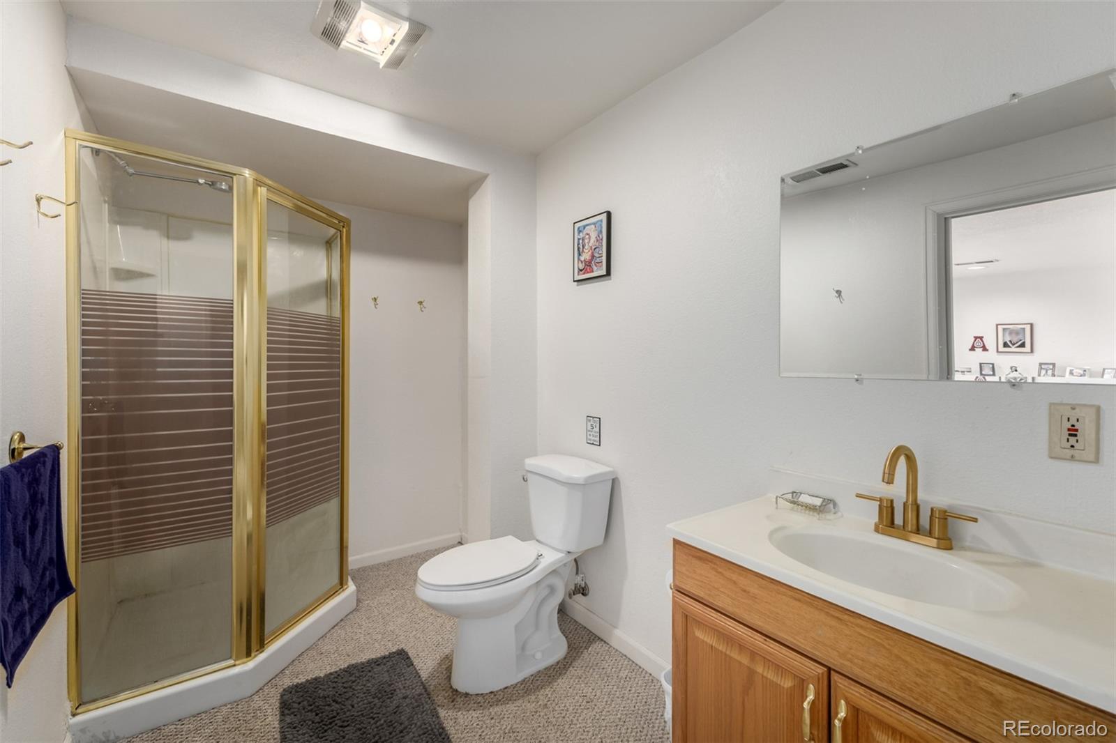707 Huntington Place Highlands Ranch, CO 80126 - Photo 38 of 50 a bathroom with a sink a toilet and shower