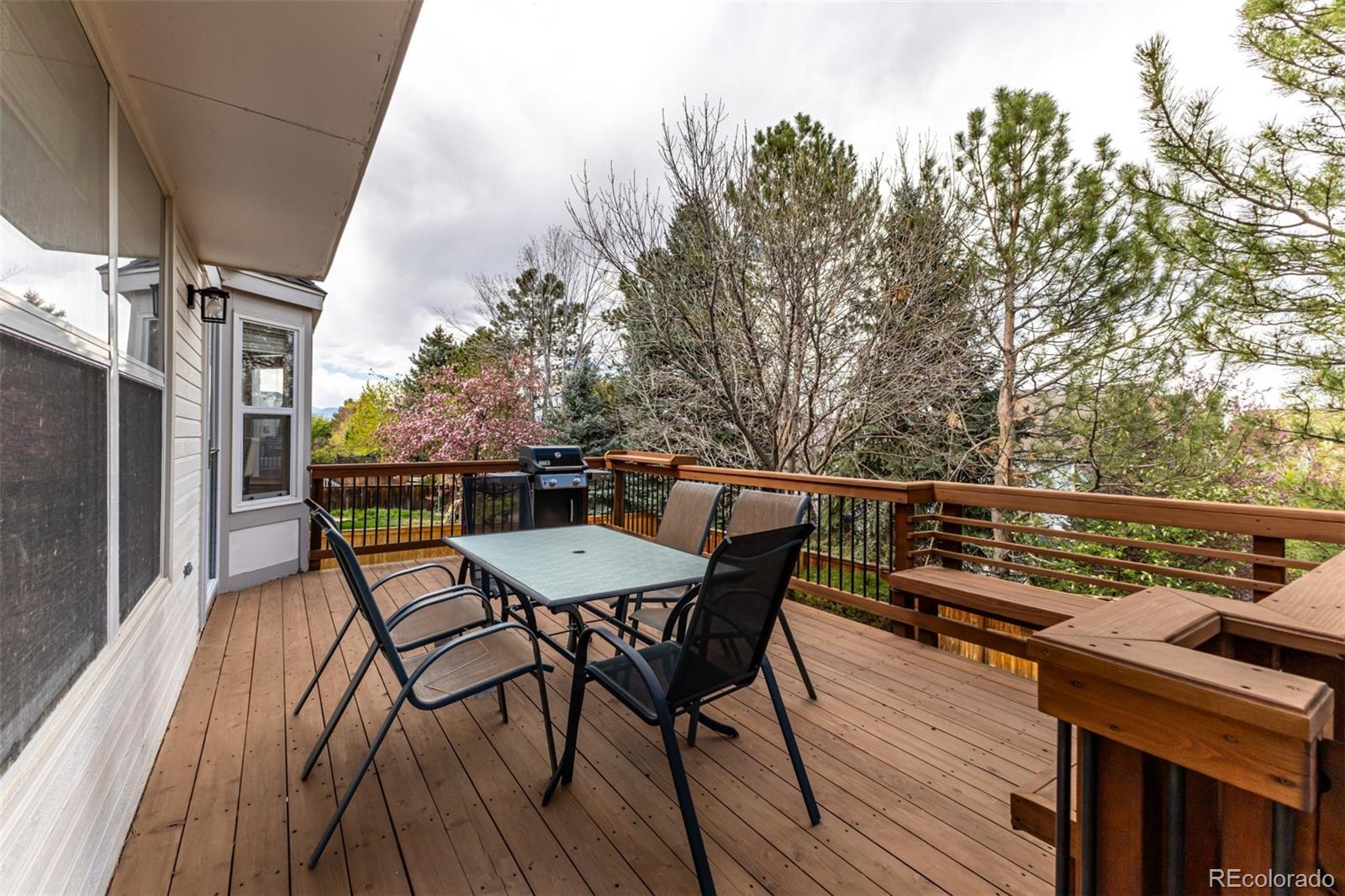 707 Huntington Place Highlands Ranch, CO 80126 - Photo 40 of 50 a view of a roof deck with table and chairs