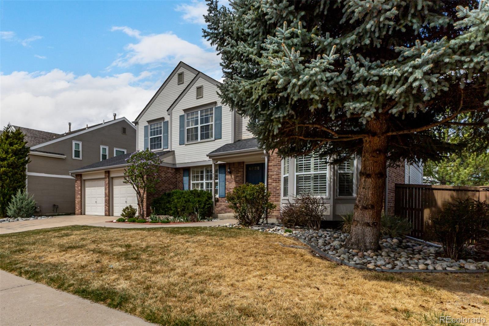 707 Huntington Place Highlands Ranch, CO 80126 - Photo 4 of 50 a front view of a house with garden