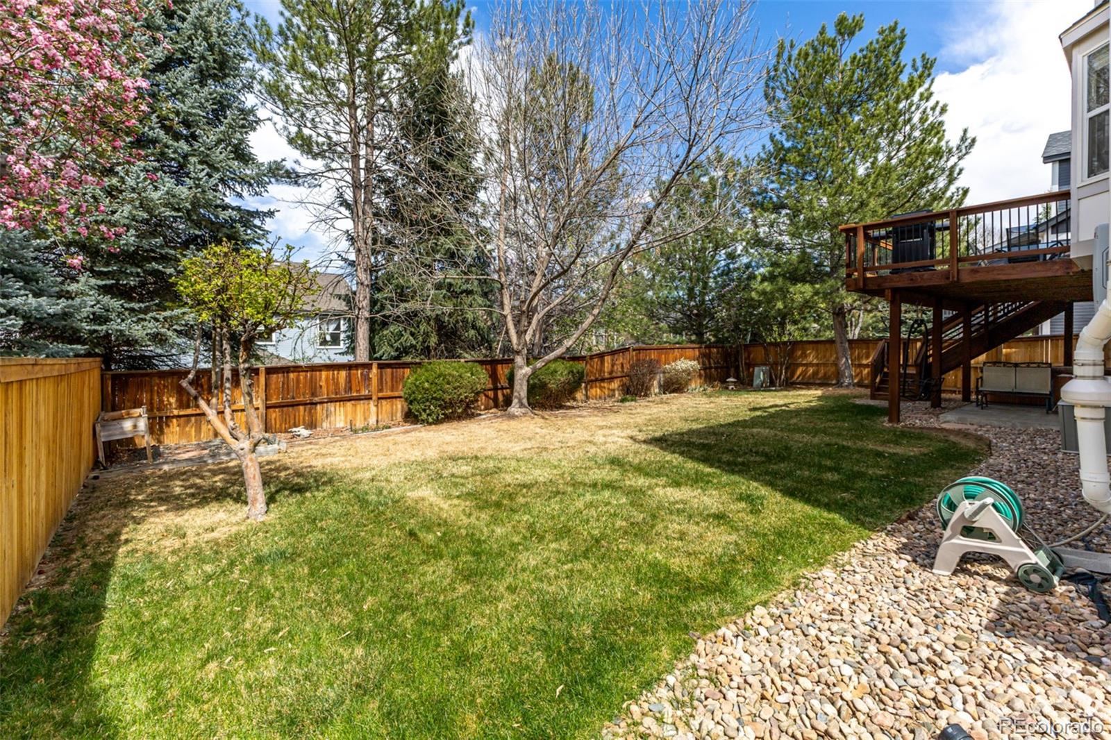 707 Huntington Place Highlands Ranch, CO 80126 - Photo 43 of 50 a backyard of a house with table and chairs