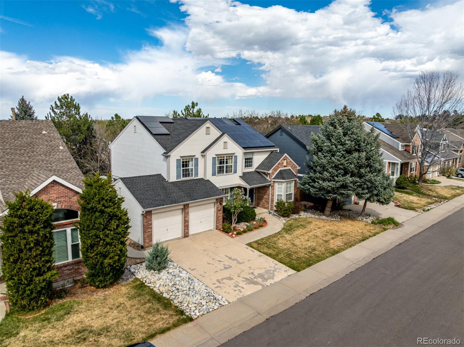 707 Huntington Place Highlands Ranch, CO 80126 - Photo 47 of 50 front view of a house with a yard