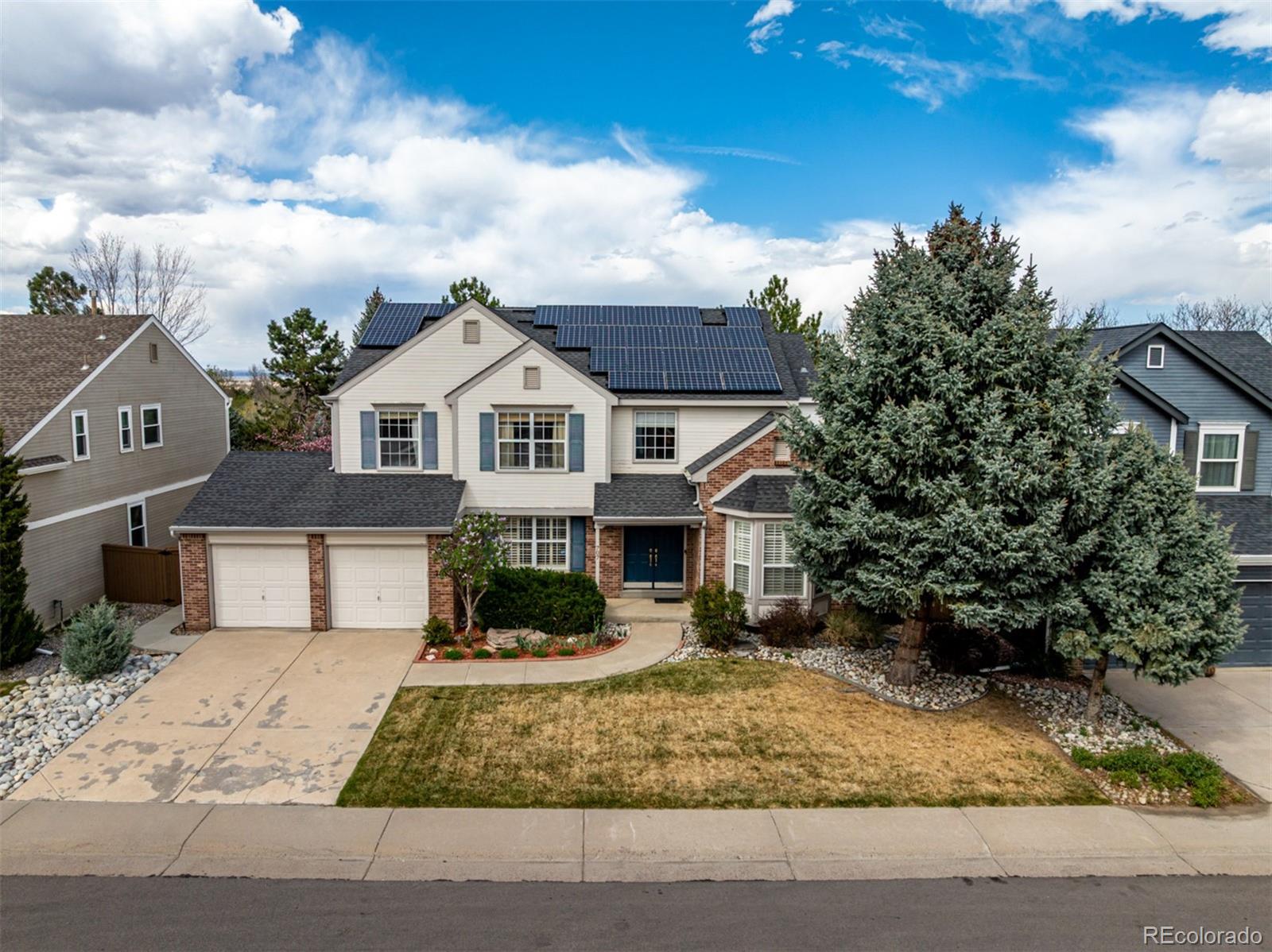 707 Huntington Place Highlands Ranch, CO 80126 - Photo 5 of 50 front view of a house with a yard