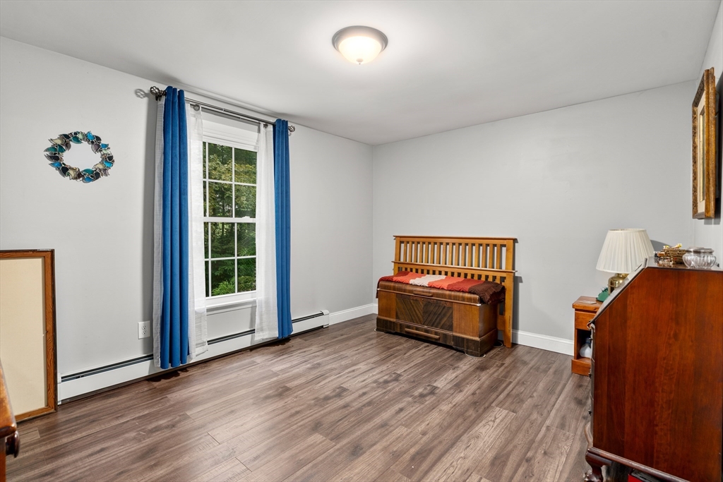 1 Sunset Rock Road Wilbraham, MA 01095 - Photo 19 of 24 a spacious bedroom with a bed and wooden floor