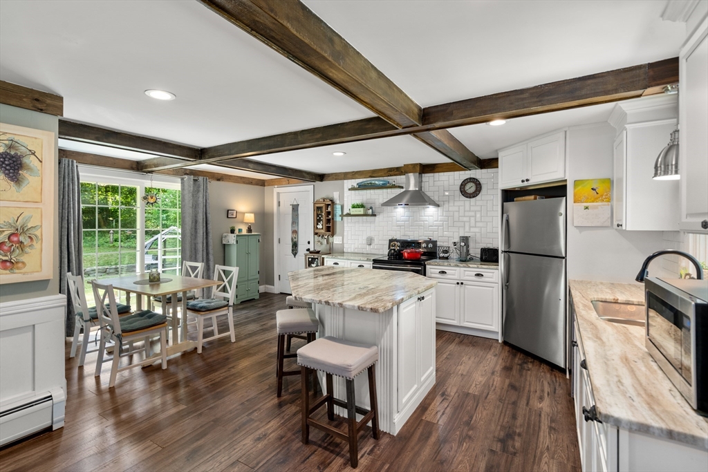 1 Sunset Rock Road Wilbraham, MA 01095 - Photo 6 of 24 a kitchen with refrigerator cabinets dining table and chairs