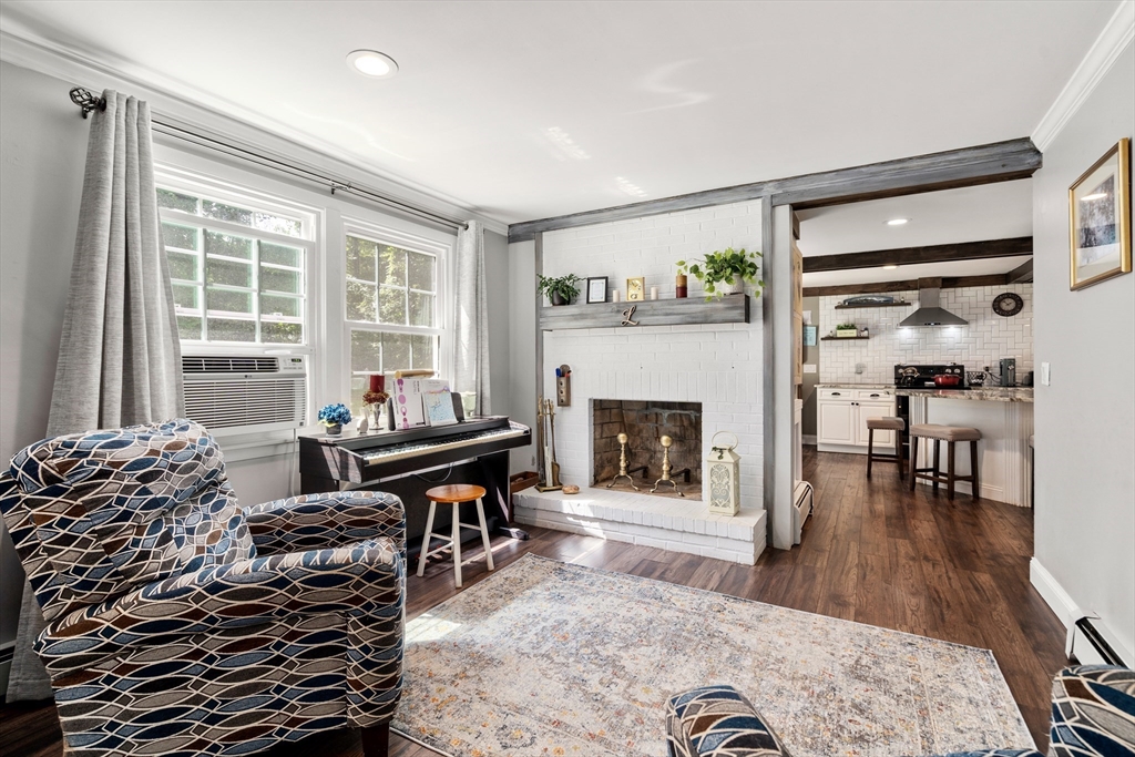 1 Sunset Rock Road Wilbraham, MA 01095 - Photo 10 of 24 a living room with furniture a fireplace and a table