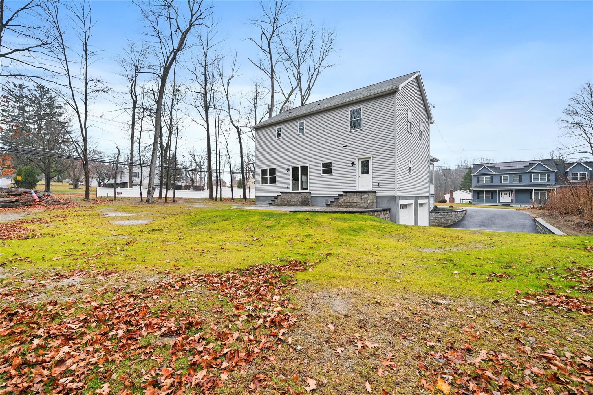 2685 Gregory Street Yorktown Heights, NY 10598 - Photo 34 of 35 Rear view of house featuring a lawn and a garage