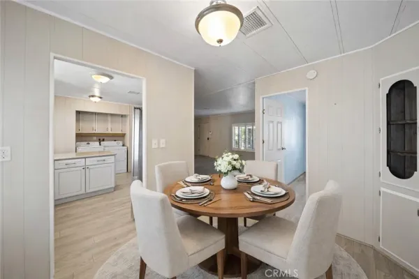 a view of a dining room that has a table and chairs in it