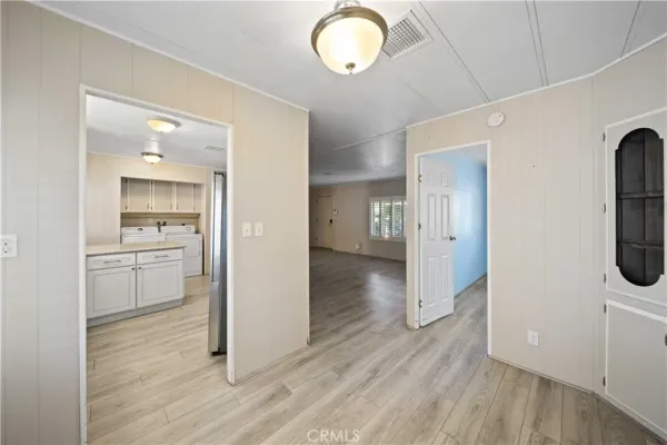 a view of a room with wooden floor and bathroom